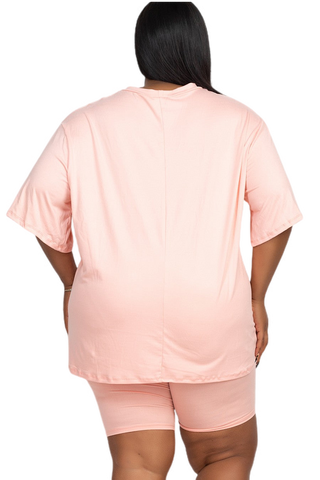 Plus size loose fit top and biker shorts set in light pink, back view. Comfortable, lightweight, and breathable fabric.