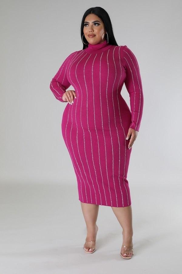 Plus size woman in magenta turtle neck dress with rhinestone detailing, long sleeves, showcasing stylish and elegant fit.