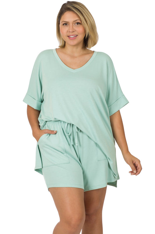 Woman wearing mint green plus-size brushed DTY microfiber top and biker shorts set with a hi-low hem and side slits.