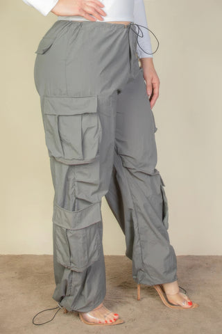 Plus Size Flap Pockets Drawstring Ruched Parachute Pants in gray with non-stretch fabric, shown on model wearing high heels.