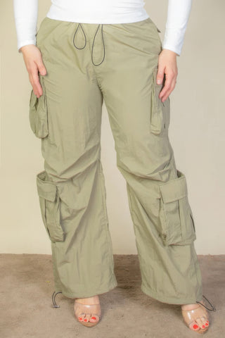 Plus size flap pockets drawstring ruched parachute pants in olive green, featuring cargo style and nylon fabric.