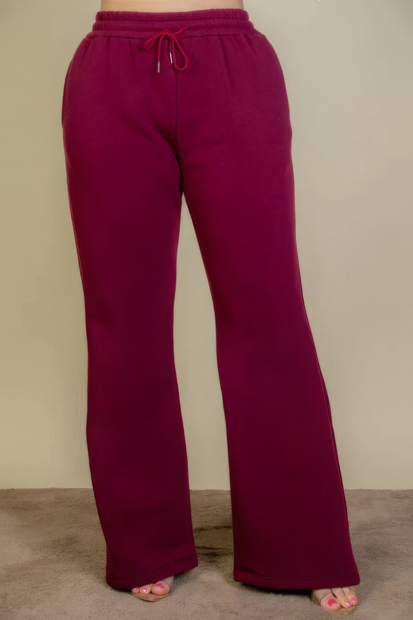 Plus size bootcut sweatpants with drawstring waist and slant pockets in red.