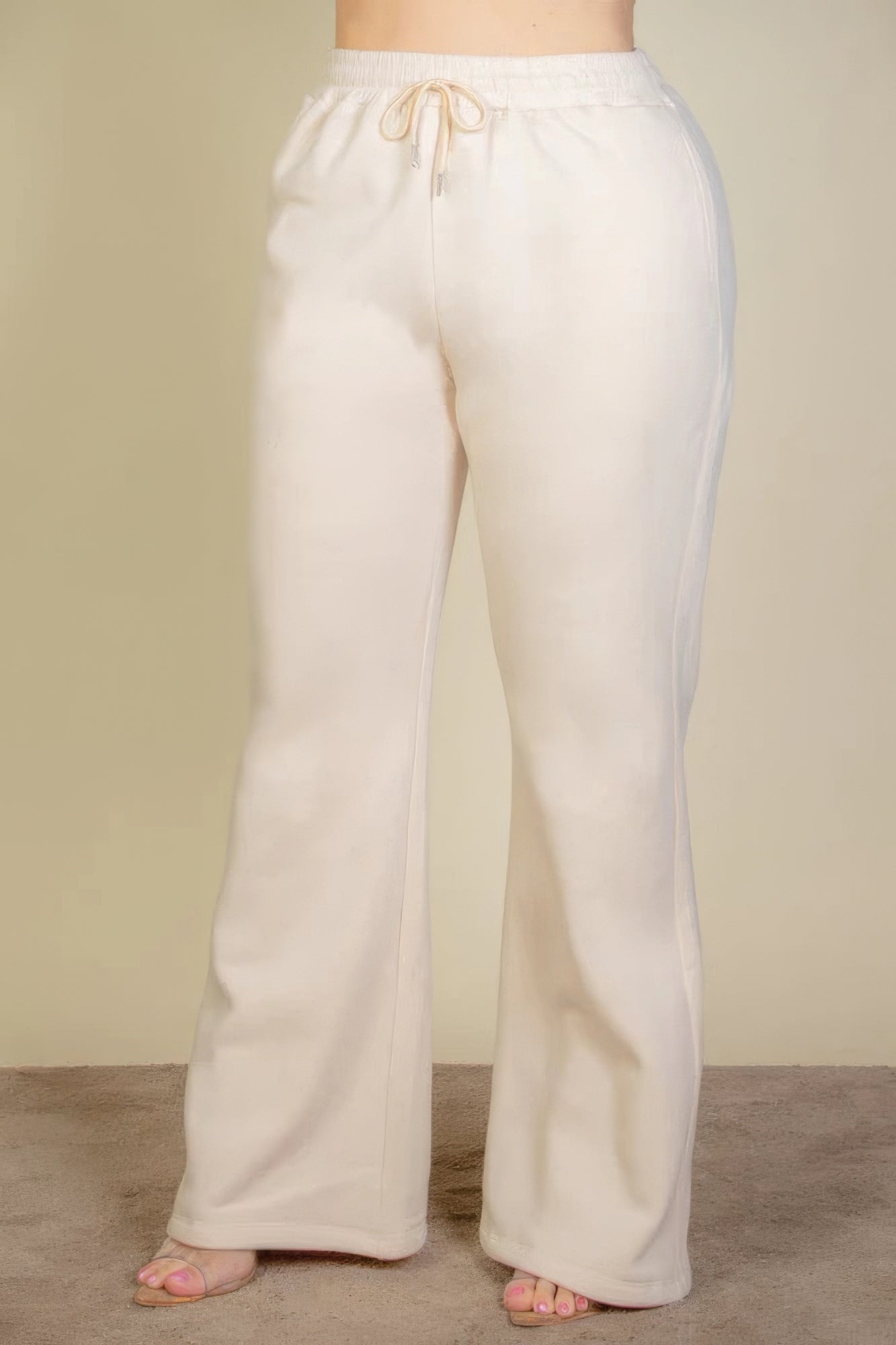 Plus size drawstring waist slant pocket sweatpants in cream color with bootcut silhouette, perfect for casual wear and comfort.