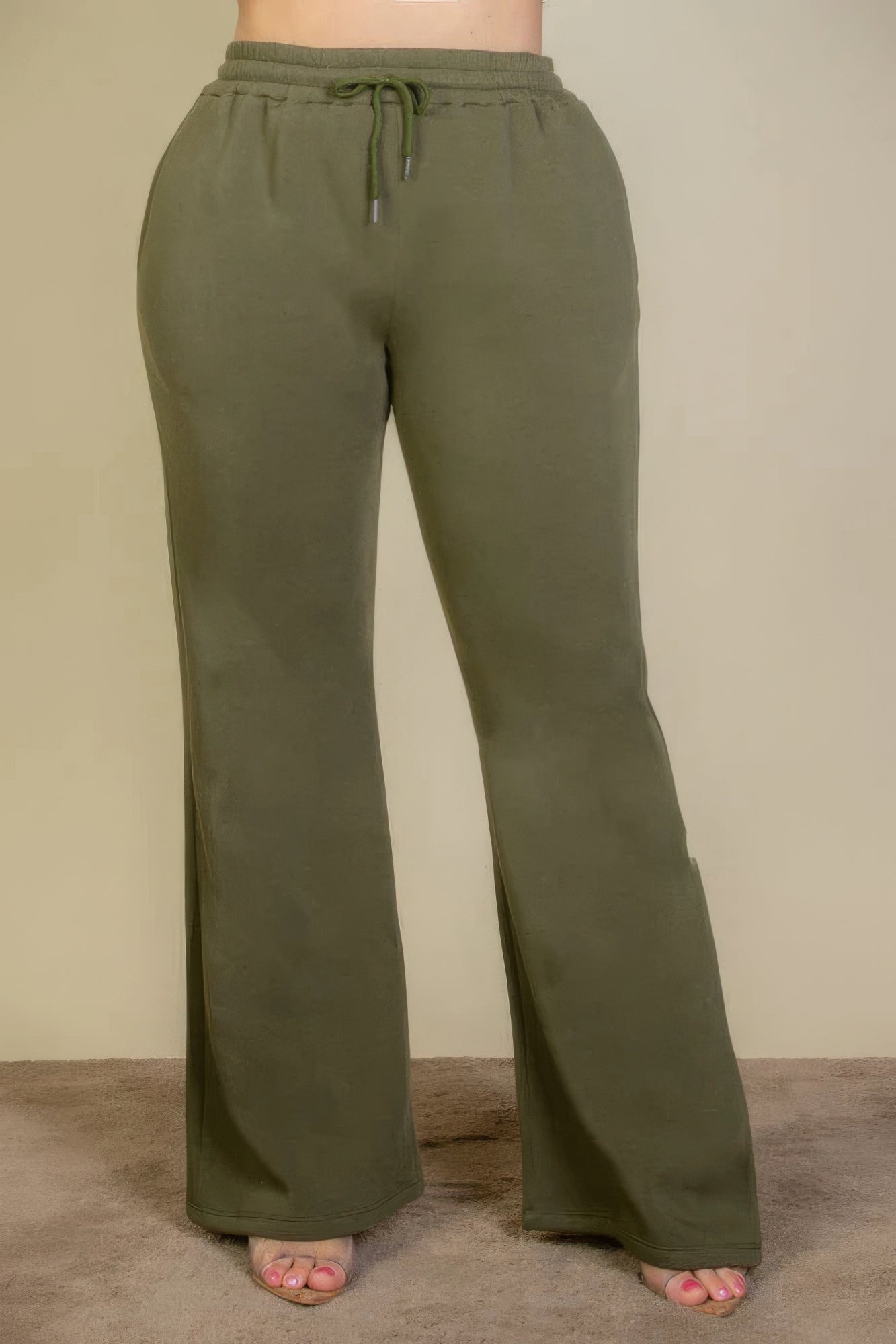 Olive plus size sweatpants with drawstring waist and slant pockets, featuring a flattering bootcut silhouette for versatile wear.