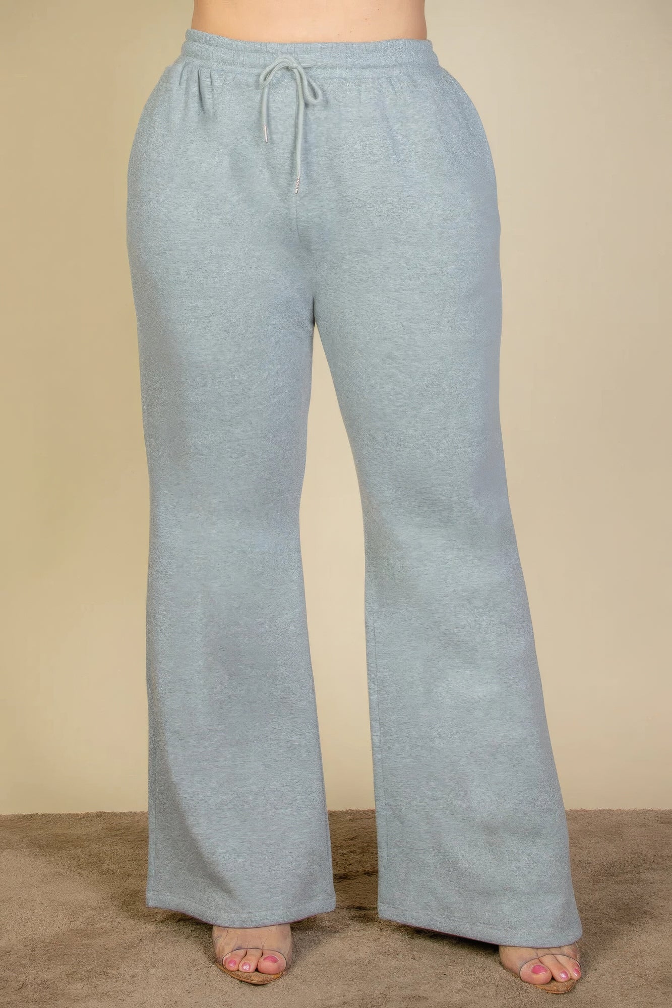 Plus size drawstring waist sweatpants with slant pockets in soft gray fabric, bootcut style, perfect for lounging or casual wear.