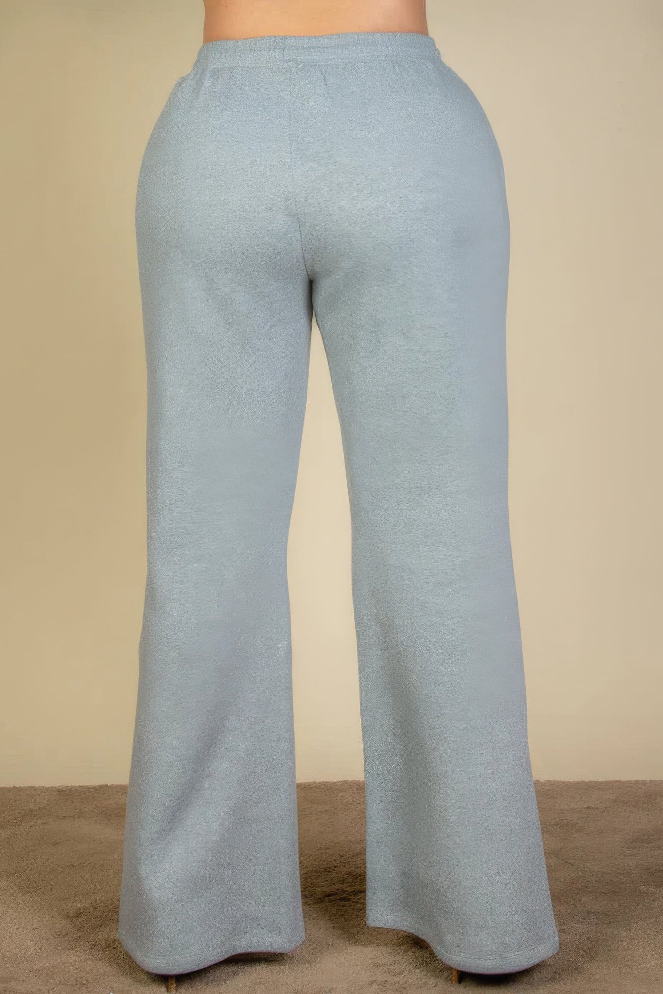 Plus size bootcut sweatpants in soft blue, featuring drawstring waist and slant pockets, offering stylish comfort and versatility.