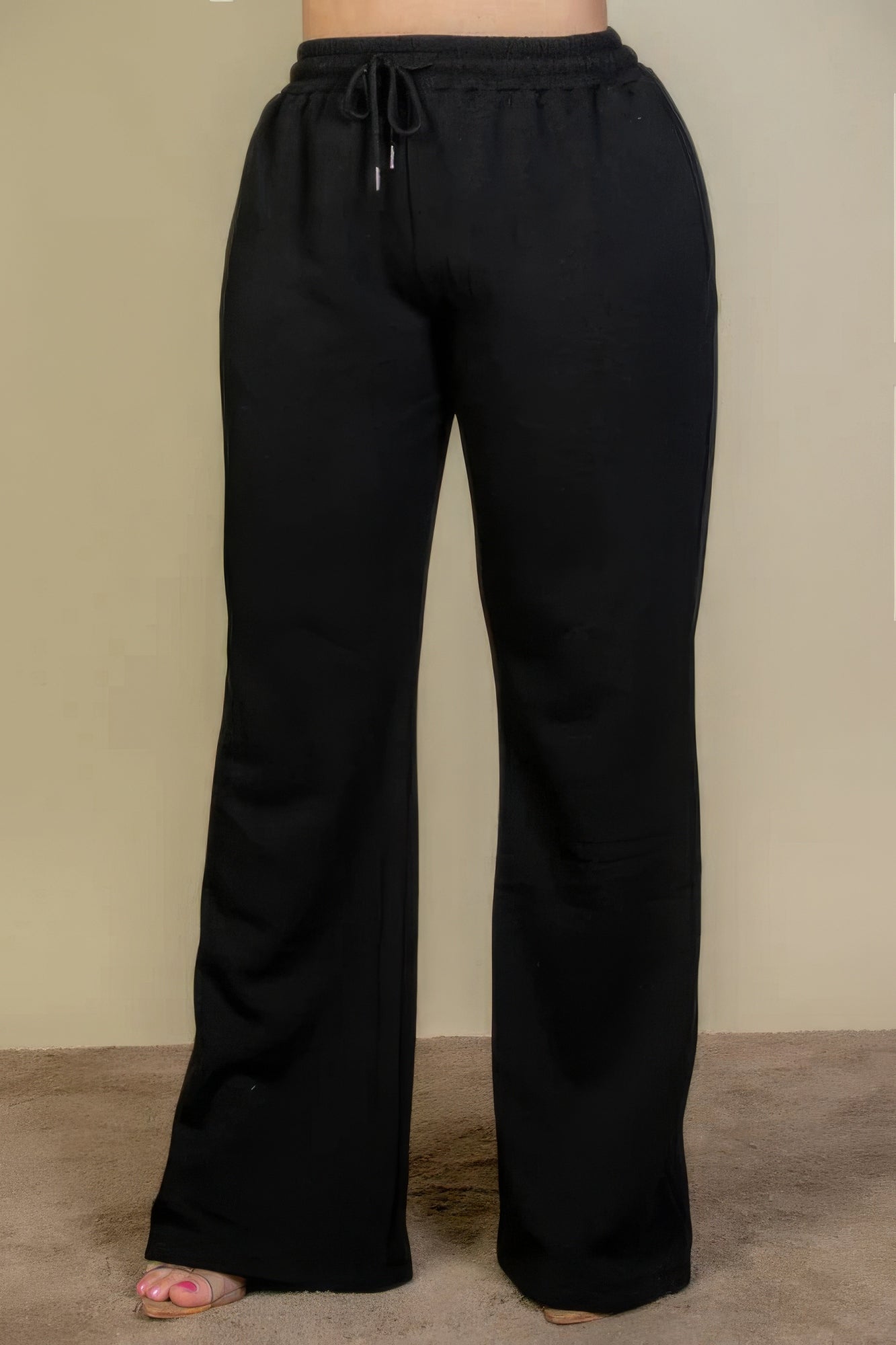 Plus size black bootcut sweatpants with drawstring waist and slant pockets for style and comfort.