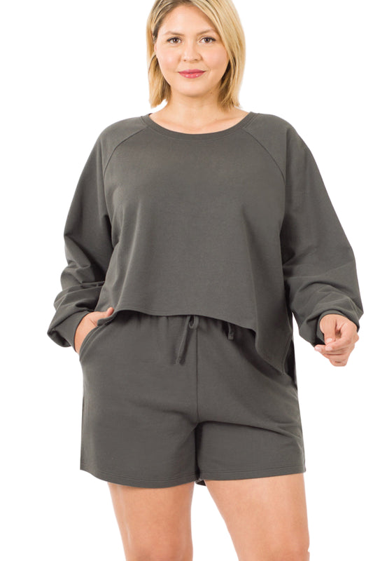 Plus size model in ash grey raglan sleeve top and shorts set, showcasing relaxed fit and stylish side slits.