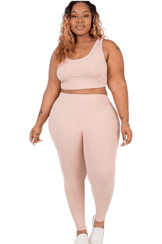 Plus size model wearing ribbed crop top and leggings set in soft, comfortable fabric, perfect for loungewear or sports activities.