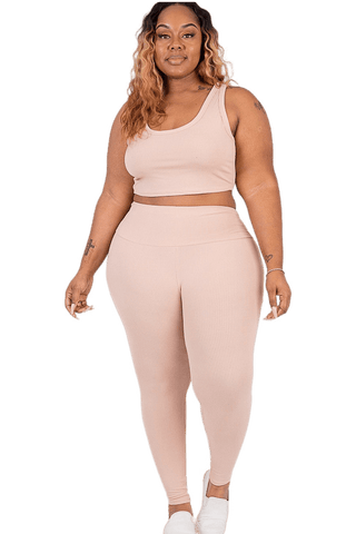 Plus size model wearing ribbed crop top and leggings set in soft, comfortable fabric, perfect for loungewear or sports activities.