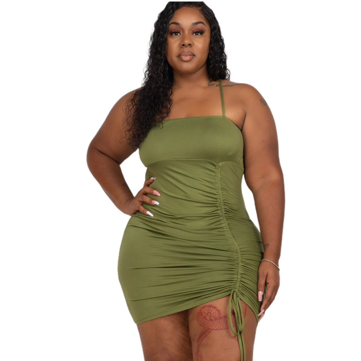 Plus size green ruched spaghetti strap mini dress in polyester and spandex blend, perfect for a stylish and comfortable look.