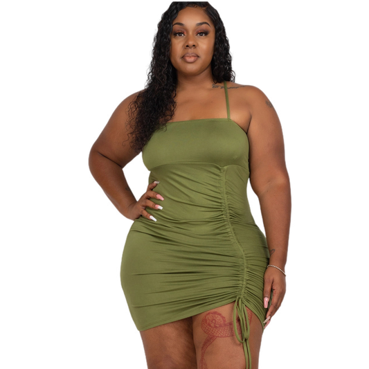 Plus size green ruched spaghetti strap mini dress in polyester and spandex blend, perfect for a stylish and comfortable look.