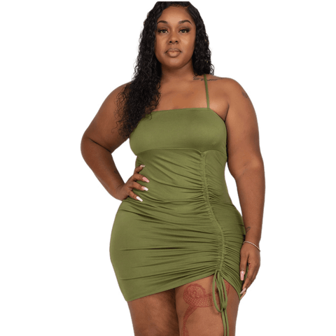 Plus size green ruched spaghetti strap mini dress in polyester and spandex blend, perfect for a stylish and comfortable look.