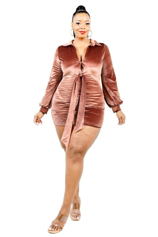 Plus size rust velvet mini dress with bishop sleeves, V-neckline, tie waist, and shirred detail.