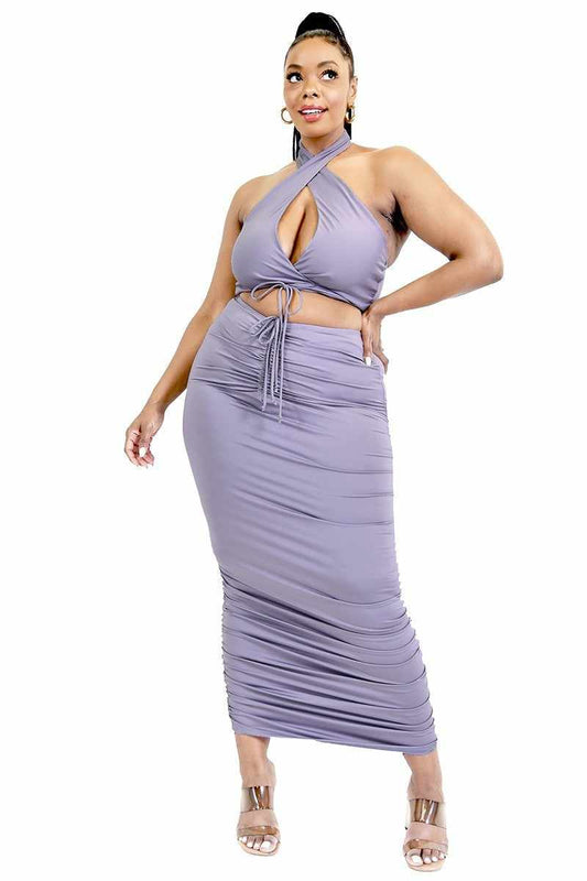 Plus size lavender two-piece halter top and skirt set, featuring tie front and stretch fabric for stylish comfort.