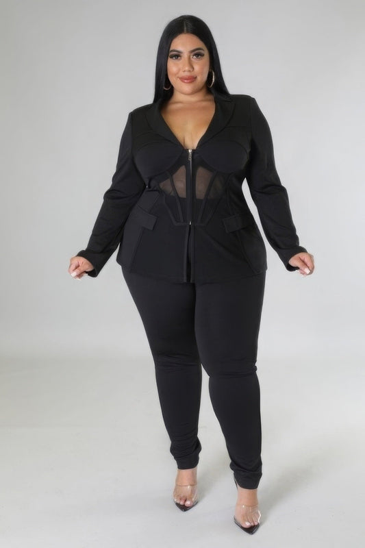 Plus size black two-piece set with long sleeve top and high-waisted pants, featuring faux pockets and zipper closure for stylish occasions.