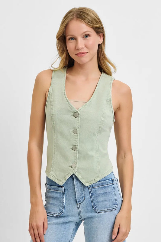 Young woman with blonde hair wearing a sage green sleeveless button-up vest over blue jeans, standing against a white background in a product photo...