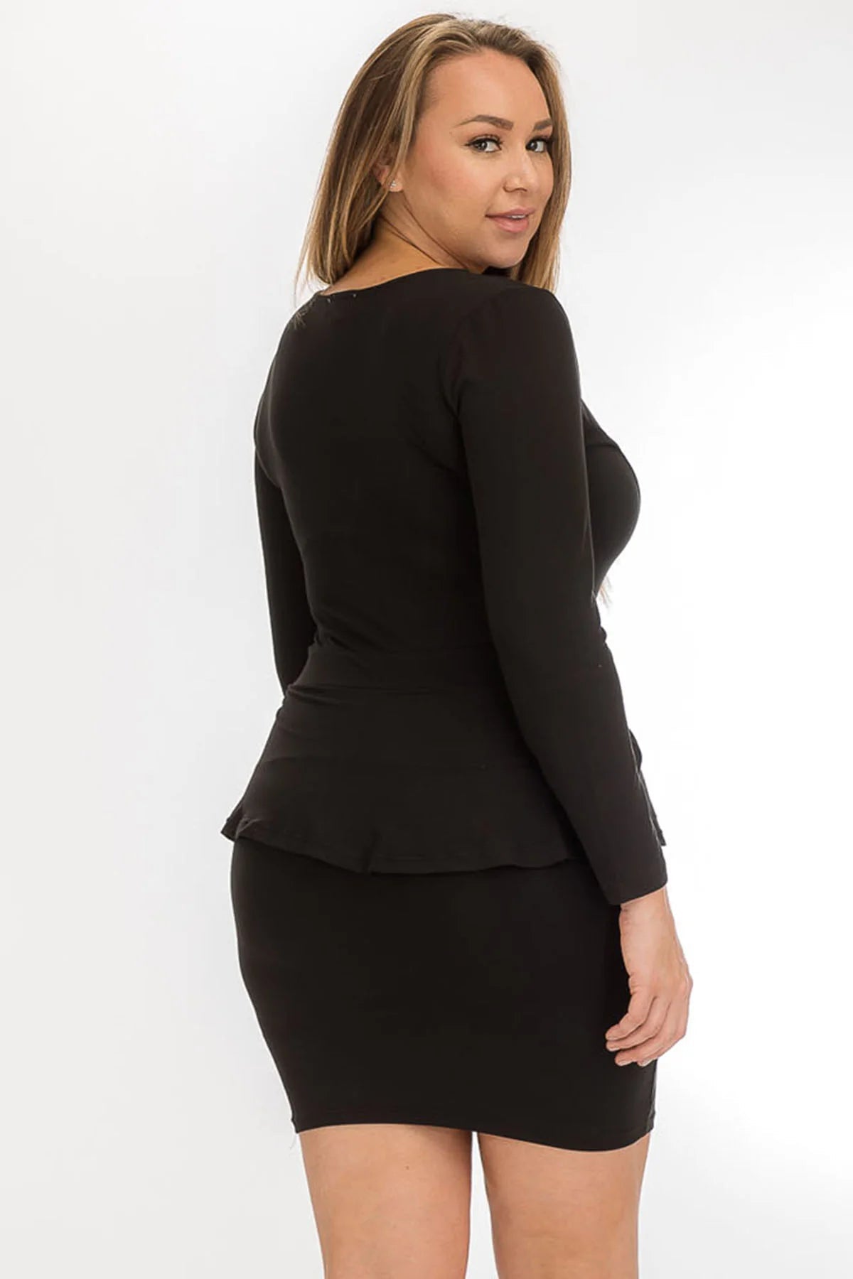 Plus size V-neck ruffled mini dress with long sleeves and stretch knit, shown on a model from the back.