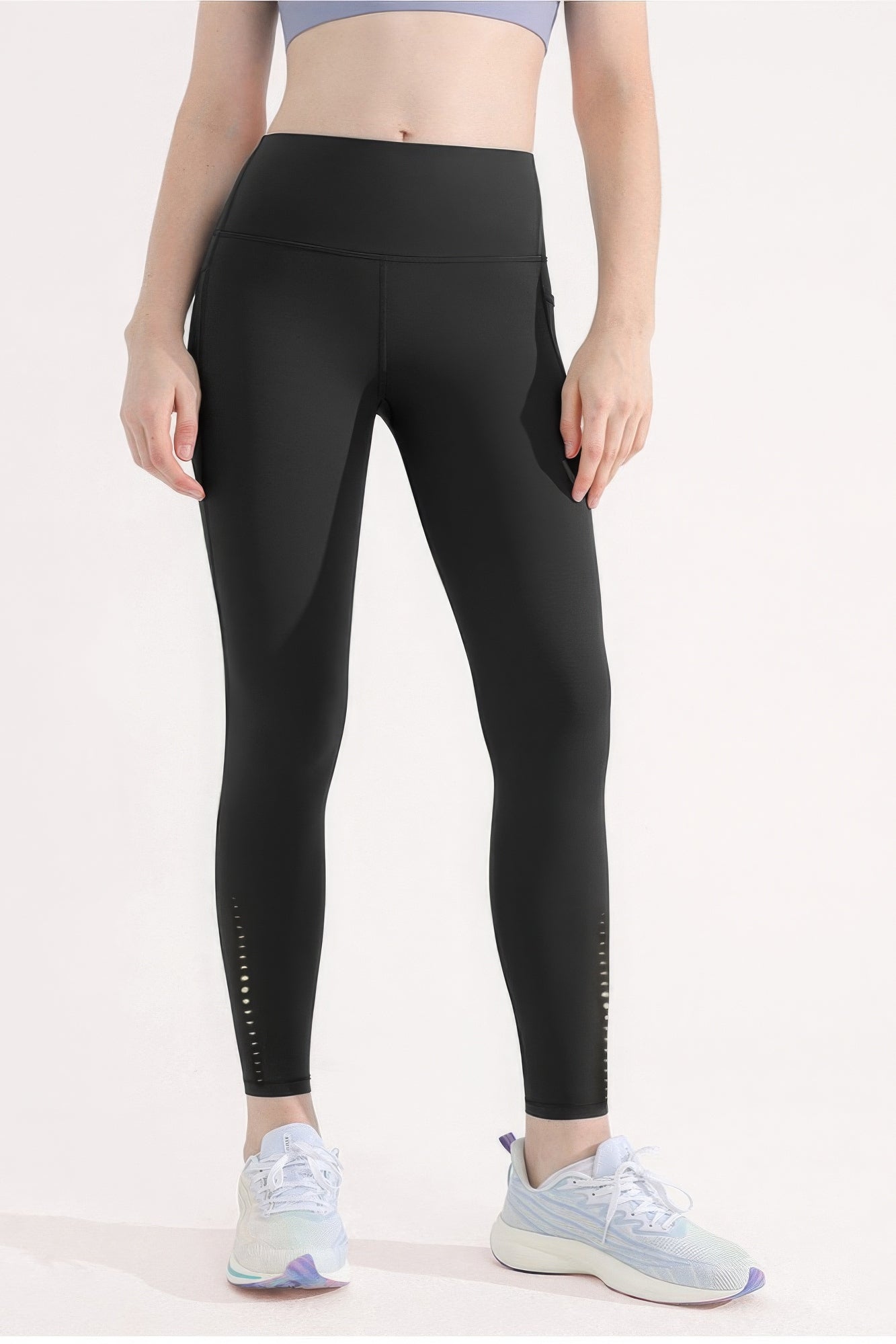 Premium black yoga leggings with high waist, pockets, and reflective dots for women, ideal for gym or casual wear.