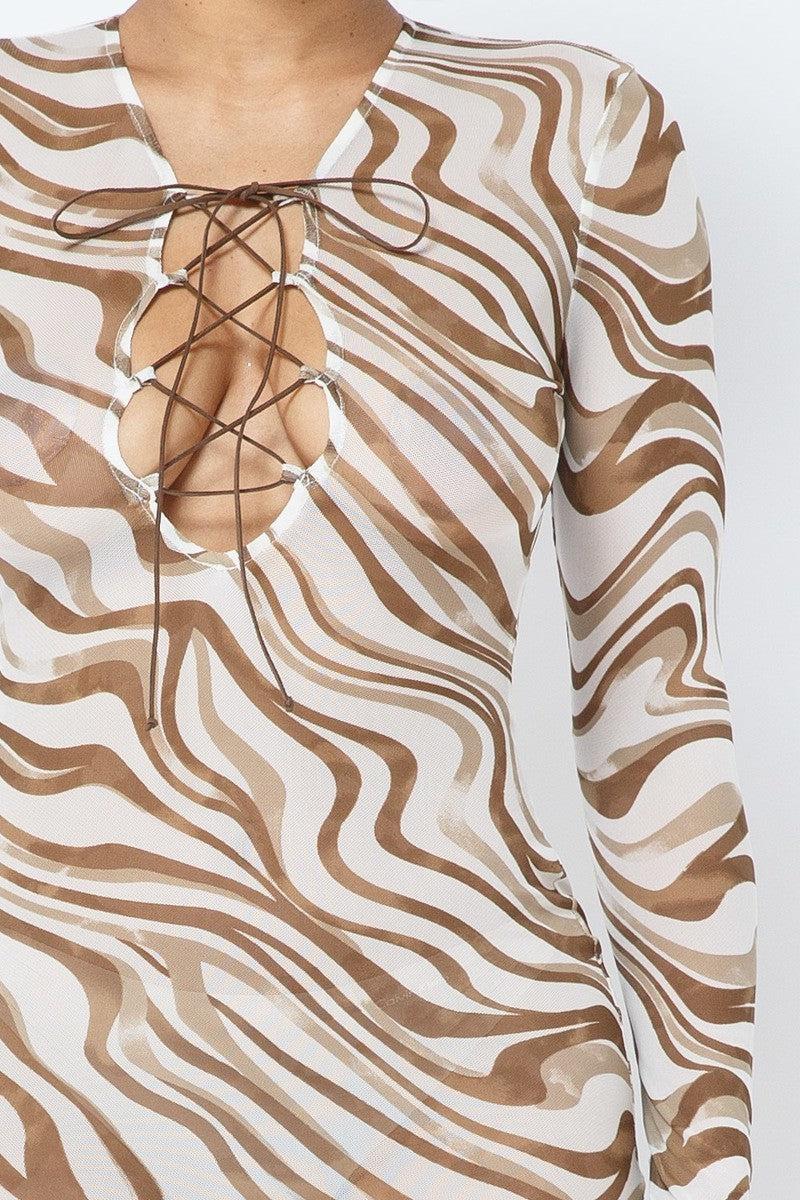 Mocha printed mesh dress with long sleeves and lace-up front design, showcasing abstract patterns.