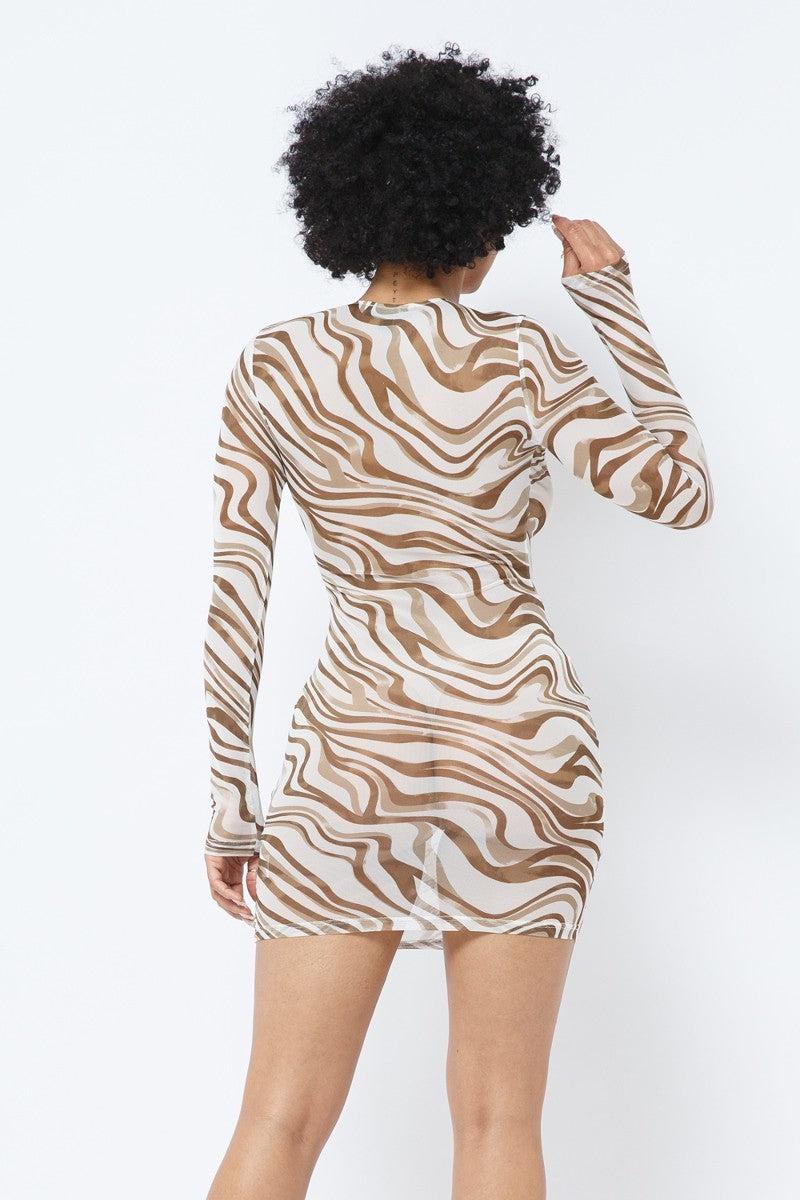 Woman wearing a long-sleeve mocha printed mesh dress, showcasing the wavy brown pattern and form-fitting style from the back view.