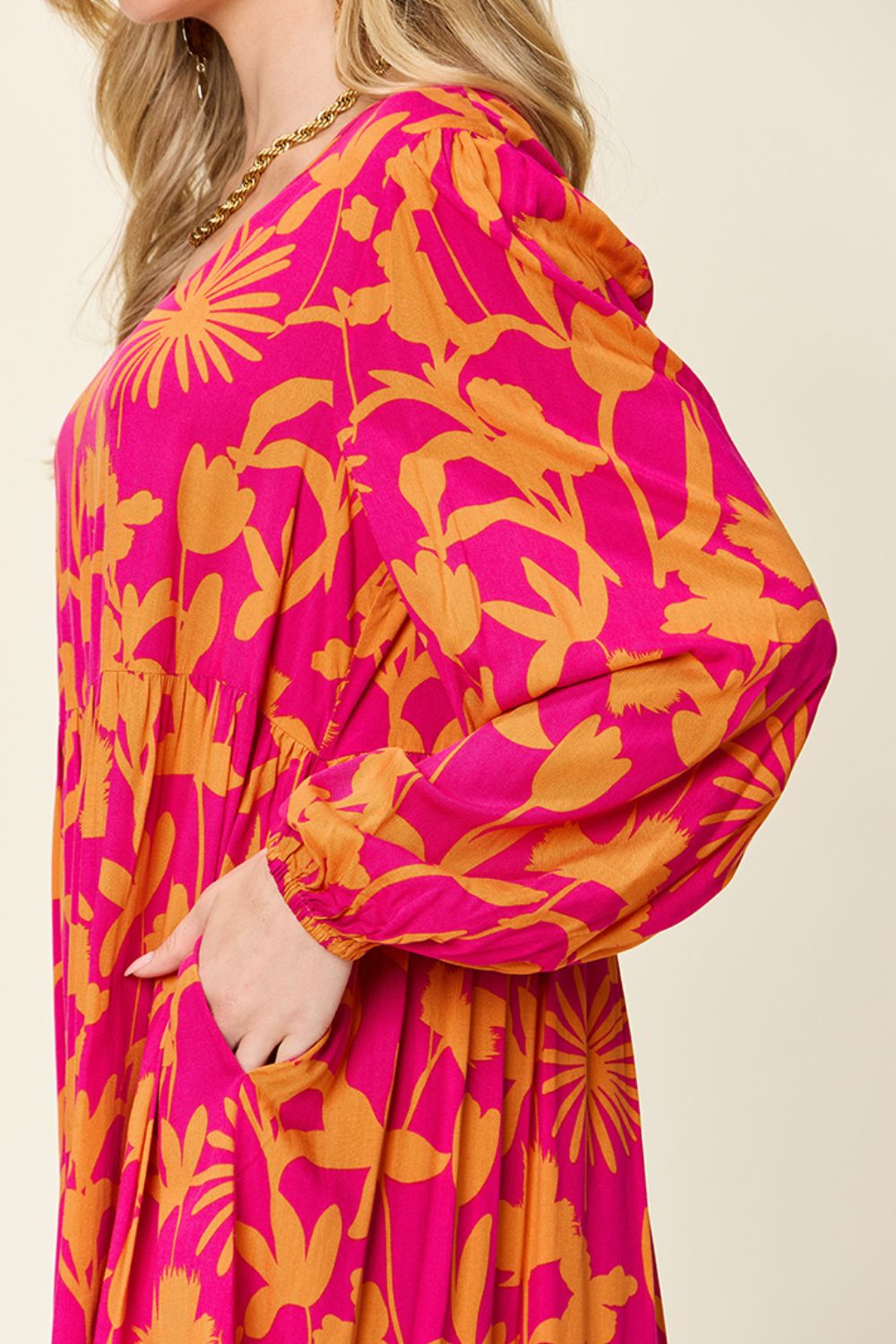 Floral printed ruffle hem dress with pocket in vibrant pink and orange, featuring long sleeves, made of 100% rayon.