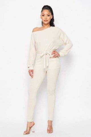 Cream off shoulder waist tie long sleeve jumpsuit made of polyester and spandex.