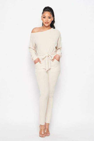 Cream off shoulder waist tie long sleeve jumpsuit made of polyester and spandex, perfect for stylish and comfortable wear.