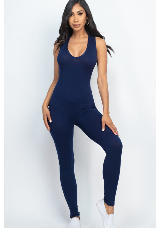 Woman wearing navy blue racer back bodycon jumpsuit showcasing soft, stretchy jersey fabric, perfect for casual and workout activities.