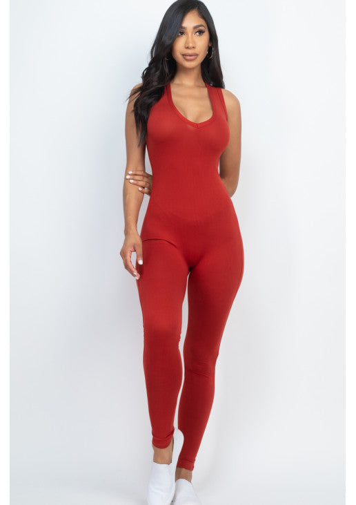 Red racer back bodycon jumpsuit in soft, stretchy jersey material, perfect for casual or workout wear, modeled by a woman.