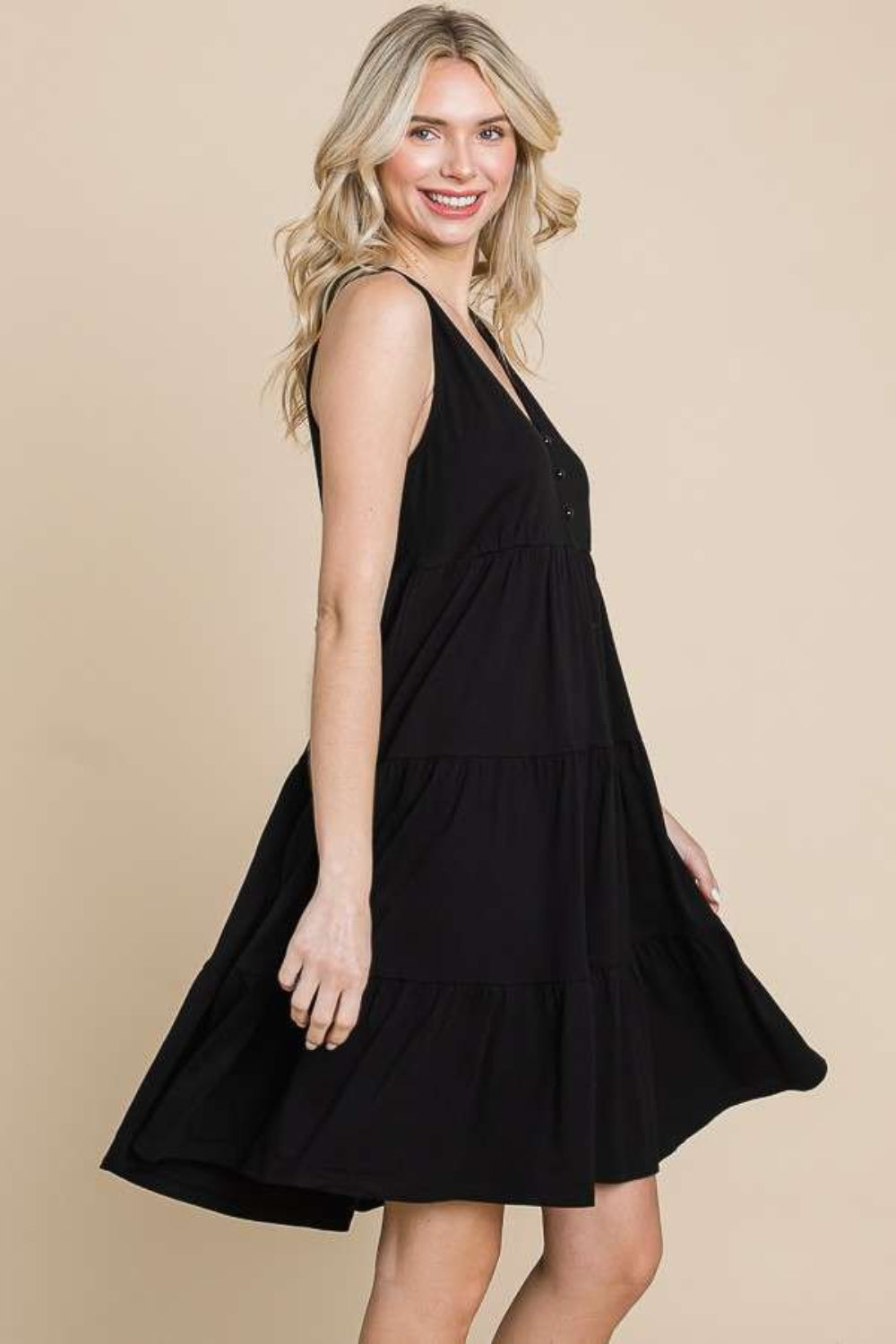 Racerback tiered tank dress in black with ruched details, slightly stretchy opaque fabric made of 60% cotton and 40% rayon.