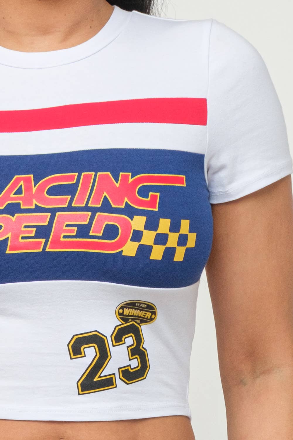 White crop top with "Racing Speed" colorful screen print and number 23 design, short sleeves, and round neck style.