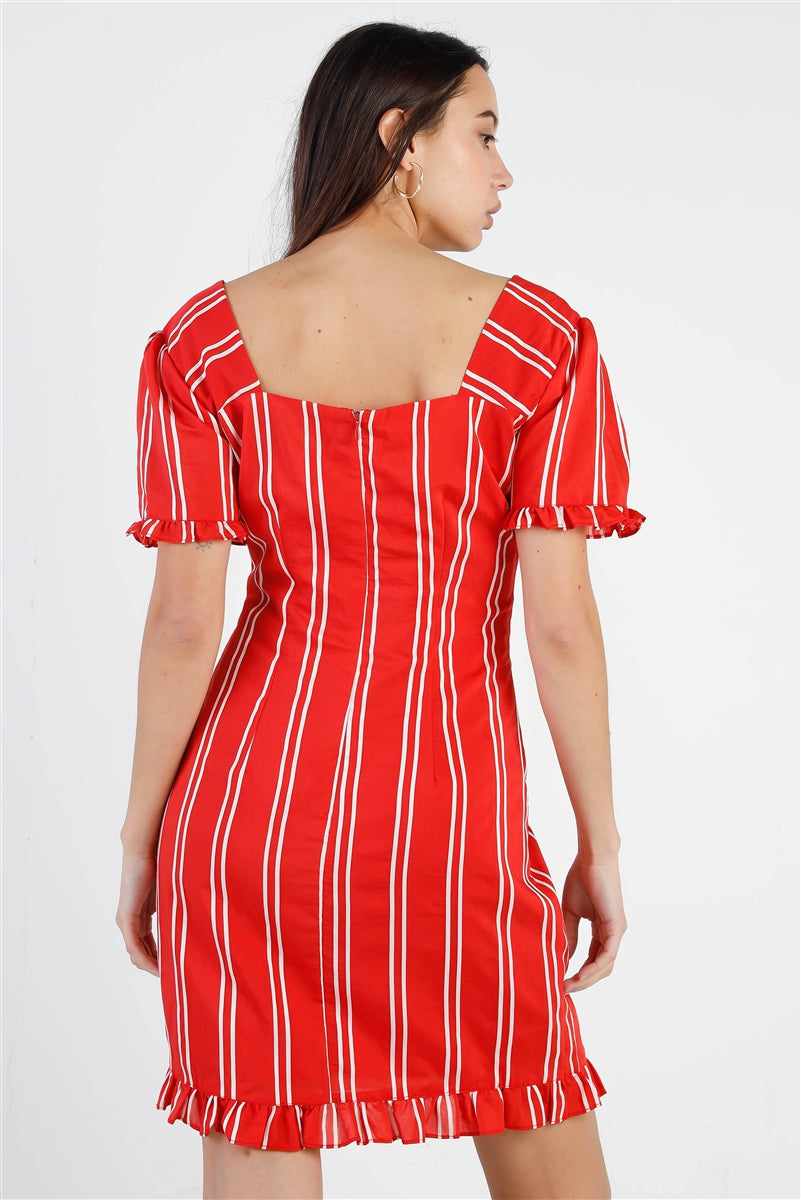 Woman wearing a red striped dress with puff balloon sleeves, lace-up front, and ruffle trim, viewed from the back.