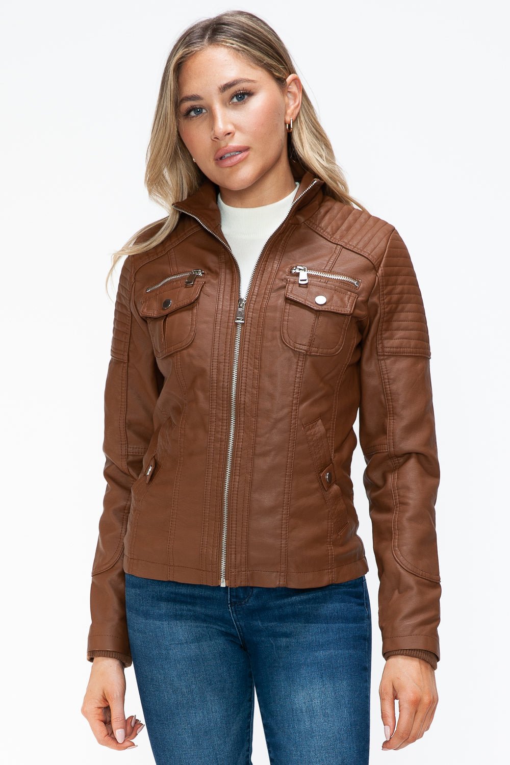 Woman wearing a removable faux layered brown jacket with multiple pockets and a zipper closure, casual style.