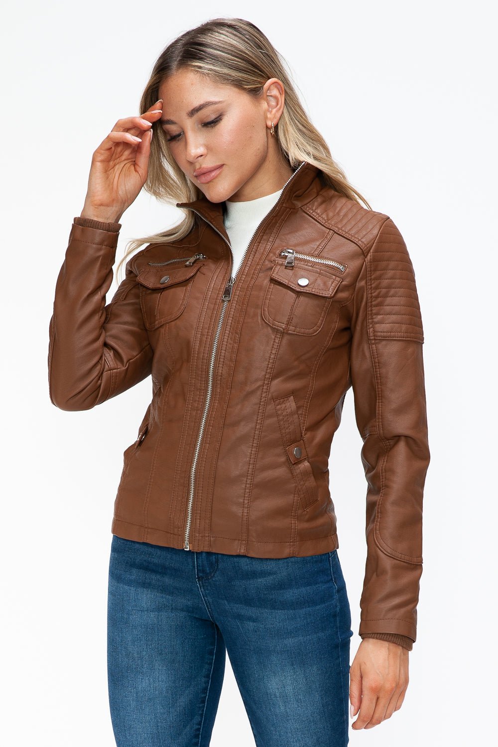 Woman wearing a removable faux layered multi-pocket jacket with a fuzzy hood, showcasing its basic style and pleather material.