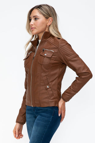 Woman wearing brown removable faux layered multi-pocket jacket with fuzzy hood, featuring a basic style and zipper closure.
