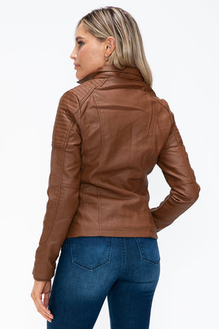 Woman wearing a brown pleather jacket with multi-pocket design and removable fuzzy hood, viewed from the back.