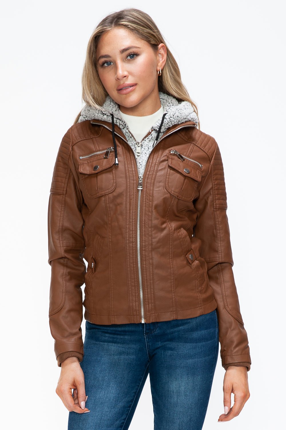 Brown faux leather jacket with removable fuzzy hood and multiple pockets, modeled by a woman wearing jeans.