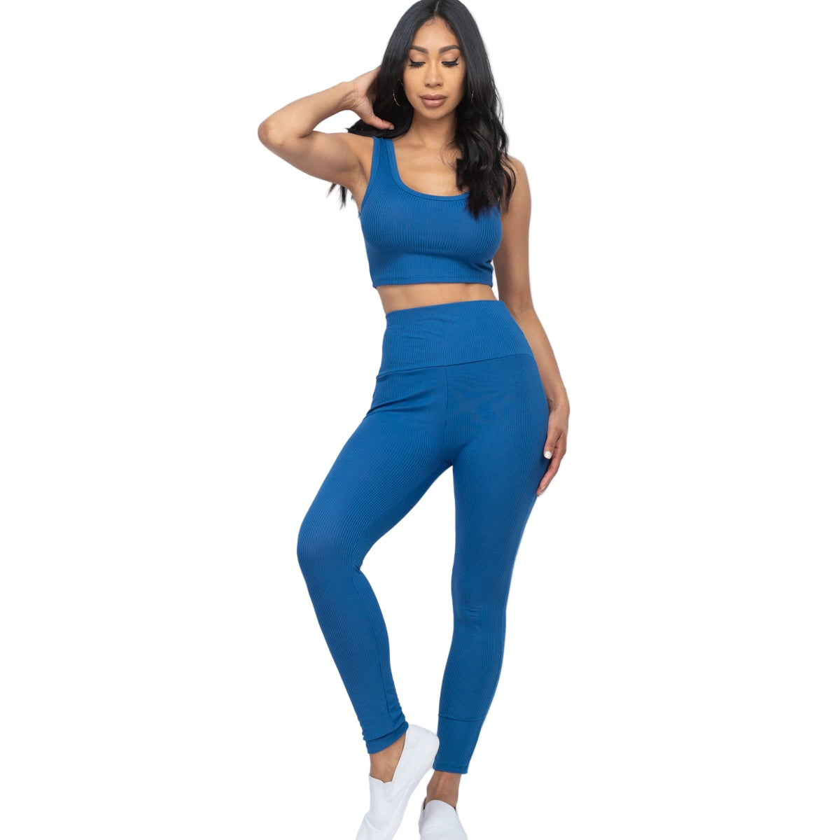 Woman wearing blue ribbed crop top and leggings set made of 92% polyester and 8% spandex. Perfect for casual or active wear.