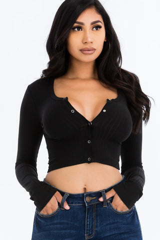 Model wearing black ribbed long sleeve snap button down crop top with high stretch knit fabric, paired with jeans.