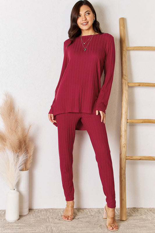 Ribbed round neck high-low slit top and pants set in burgundy, featuring two-piece design with slightly stretchy polyester-elastane blend.