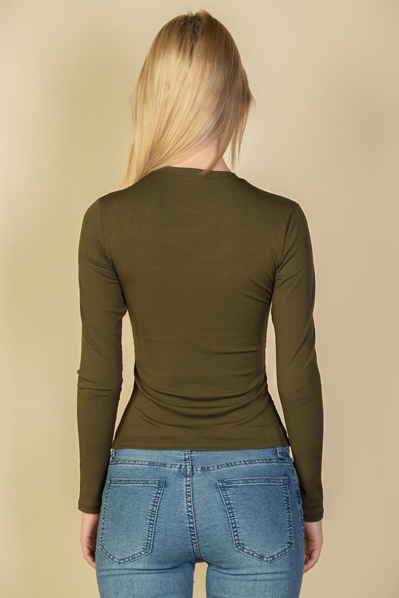 Back view of woman wearing ribbed round neck long sleeve top in olive, paired with jeans; soft stretch rib knit material.