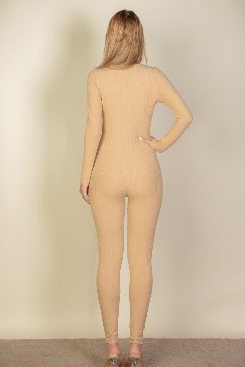 Back view of woman wearing ribbed scoop neck long sleeve jumpsuit made of soft, lightweight high stretch fabric in beige color.