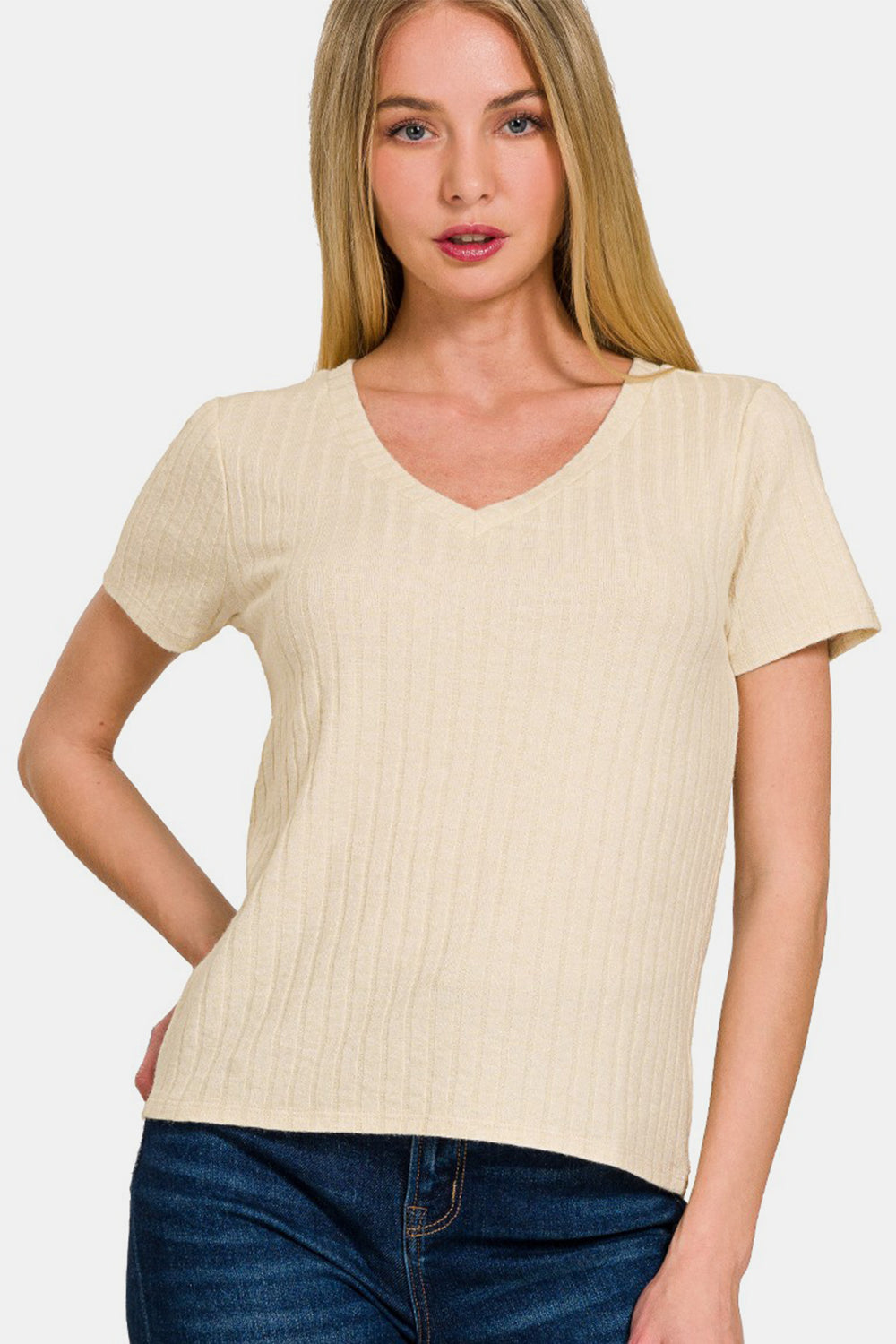 Beige ribbed short sleeve t-shirt on model, features opaque fabric with a blend of rayon, polyester, and nylon.