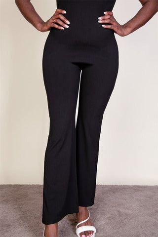 Black ribbed sleeveless wide leg jumpsuit with spaghetti straps, soft stretch fabric, 95% polyester, 5% spandex, front view.