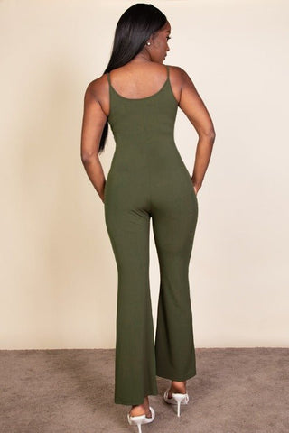 Back view of woman wearing a green ribbed sleeveless wide leg jumpsuit with spaghetti straps and medium weight stretch fabric.