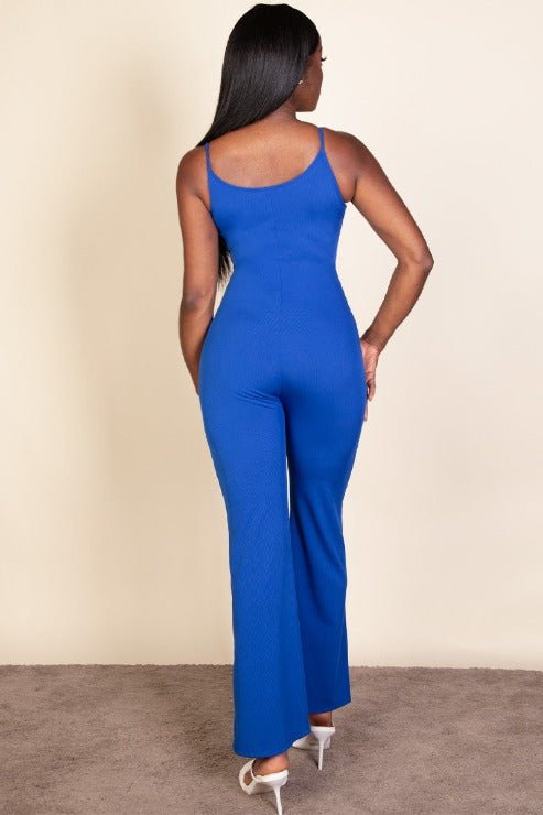 Back view of woman wearing a royal blue ribbed sleeveless wide leg jumpsuit with spaghetti straps and stretch rib knit fabric.