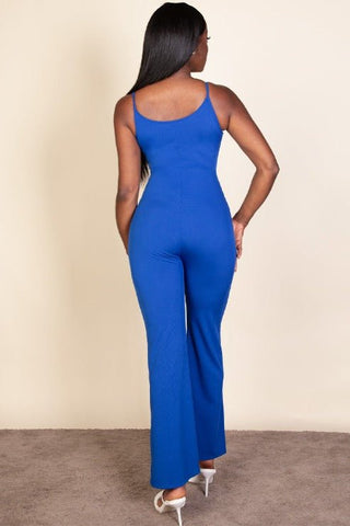 Back view of woman wearing a royal blue ribbed sleeveless wide leg jumpsuit with spaghetti straps and stretch rib knit fabric.