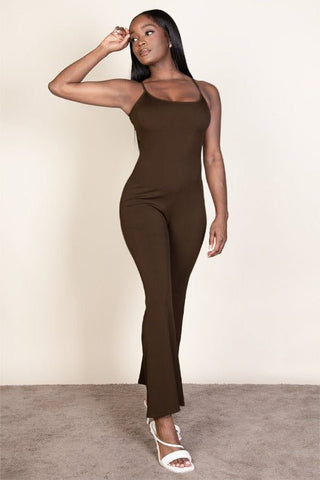 Woman wearing brown ribbed sleeveless wide-leg jumpsuit with spaghetti straps, made of soft stretch rib knit fabric, 95% polyester, 5% spandex.