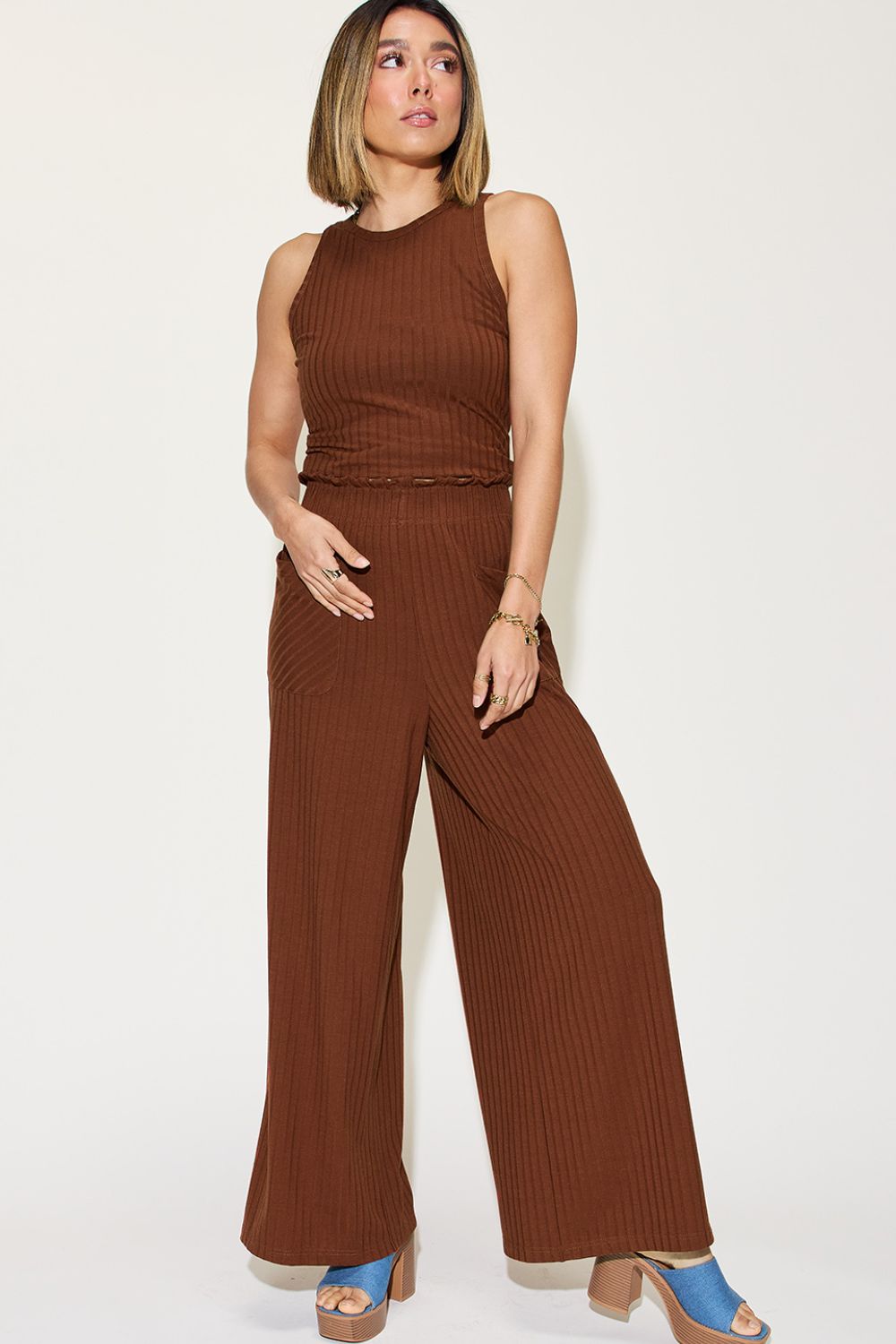 Woman wearing brown ribbed tank and wide-leg pants set with moderate stretch, frill detailing, and pockets.